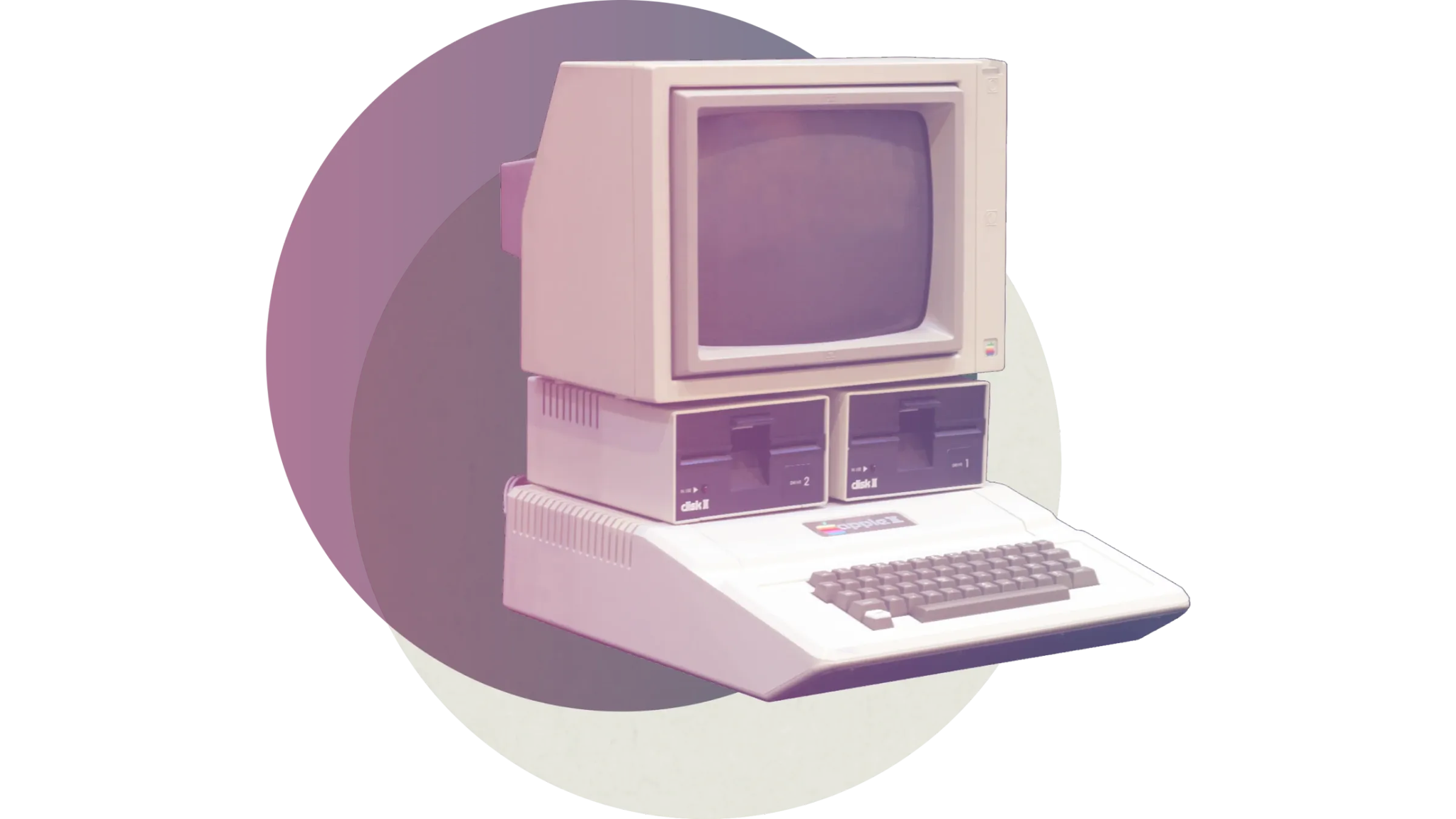 An older computer with a monitor, keyboard, and floppy drives.